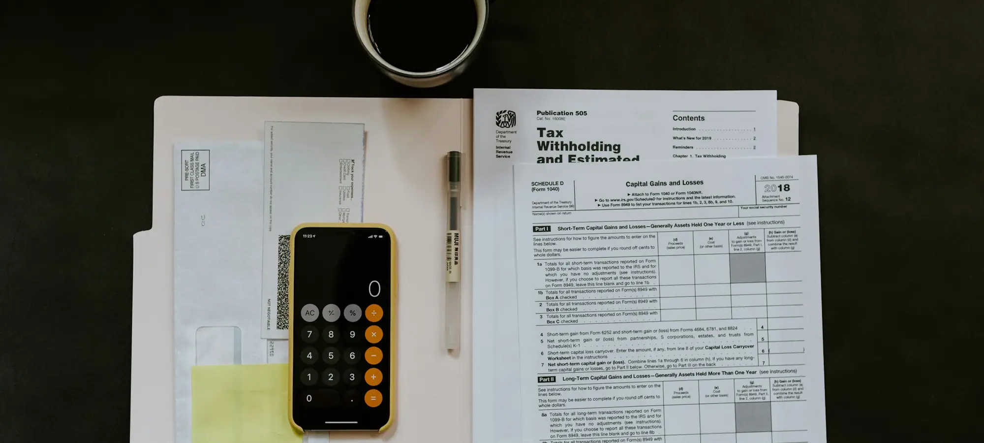 Tax and accounting paperwork with a pen and phone