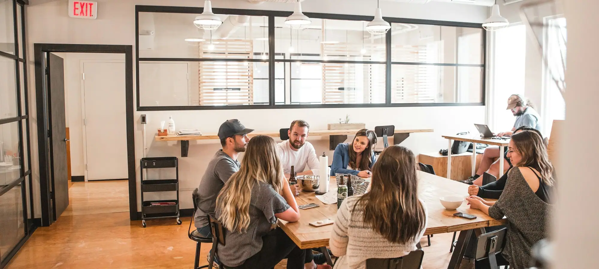 Colleagues from different teams talking around a table