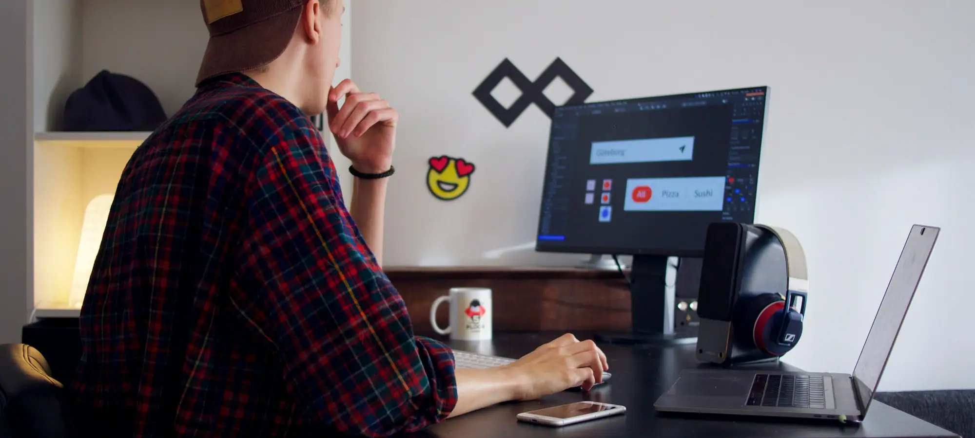 Developer working at a desk with a large monitor