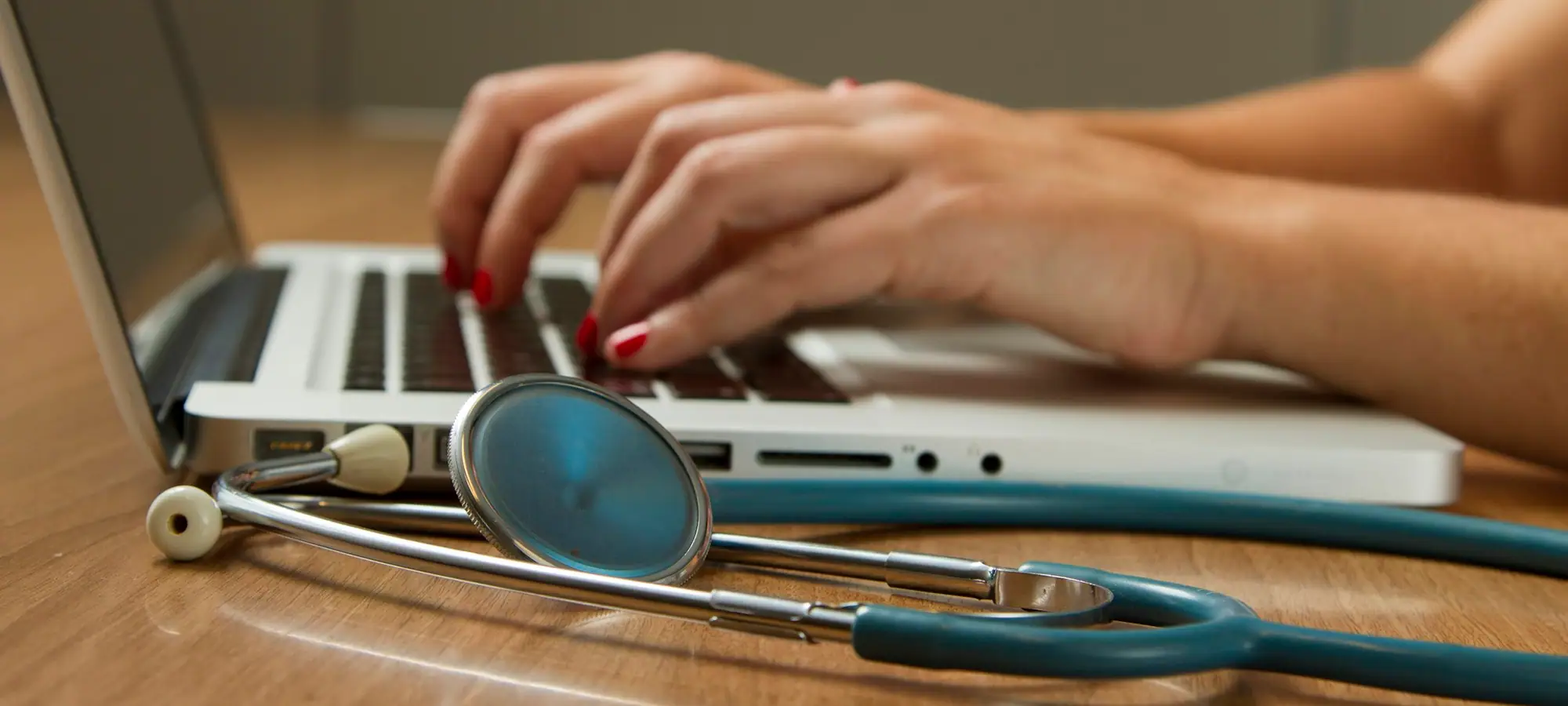 Stethoscope beside a laptop keyboard