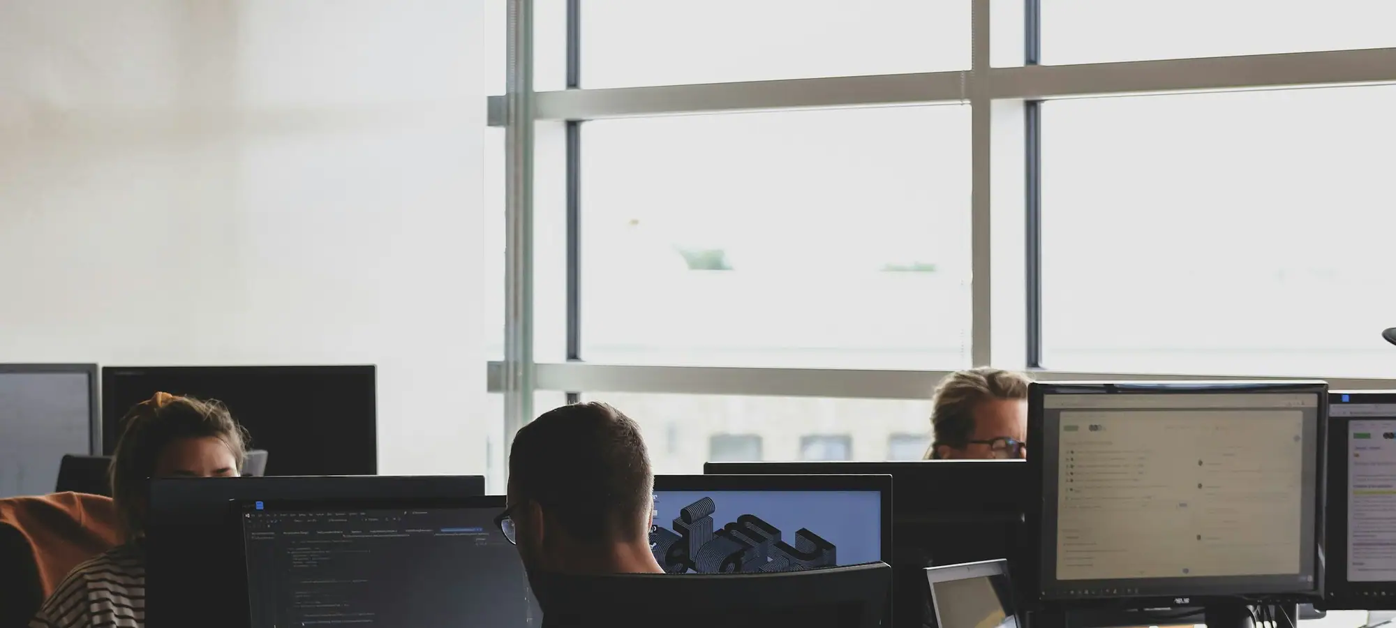 Support team working at monitors in an operations room