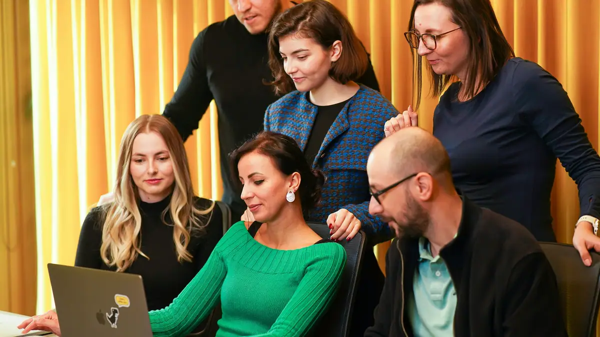 Advertising agency team reviewing work on a laptop