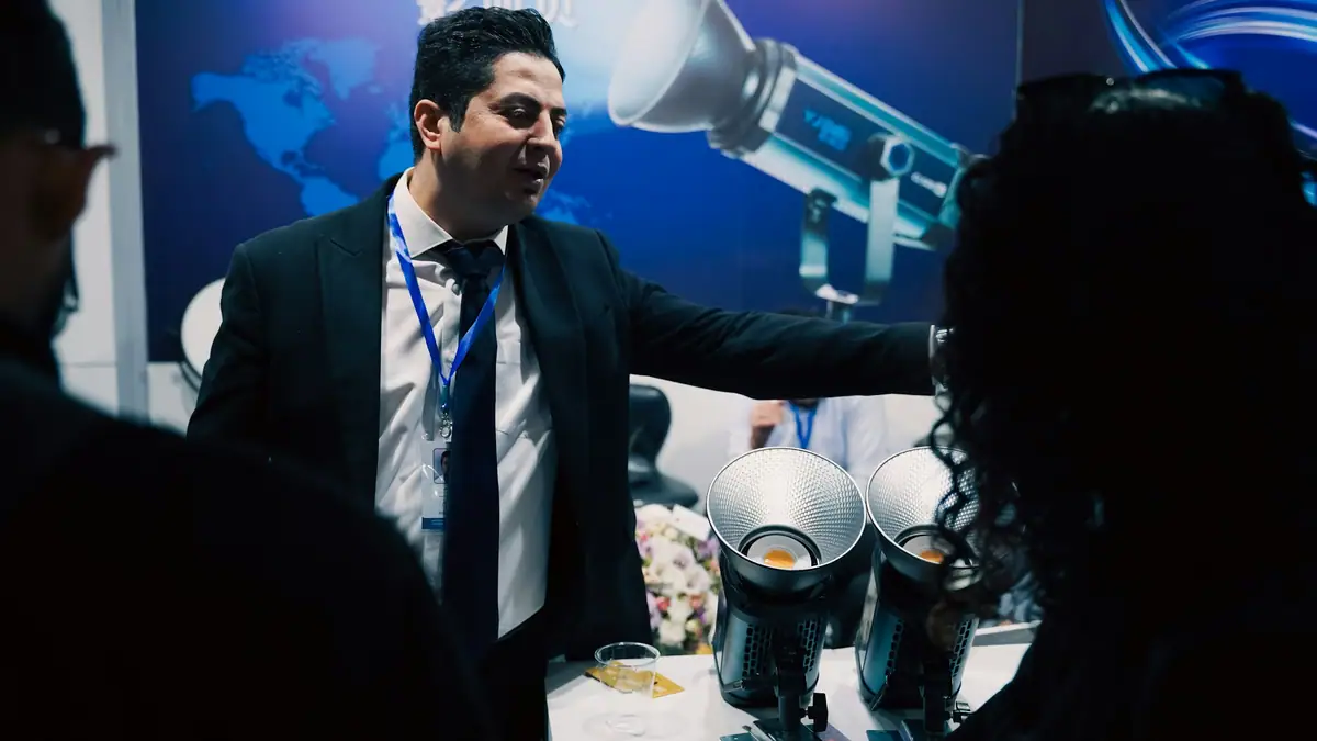 Sales representative presenting products at a trade show booth