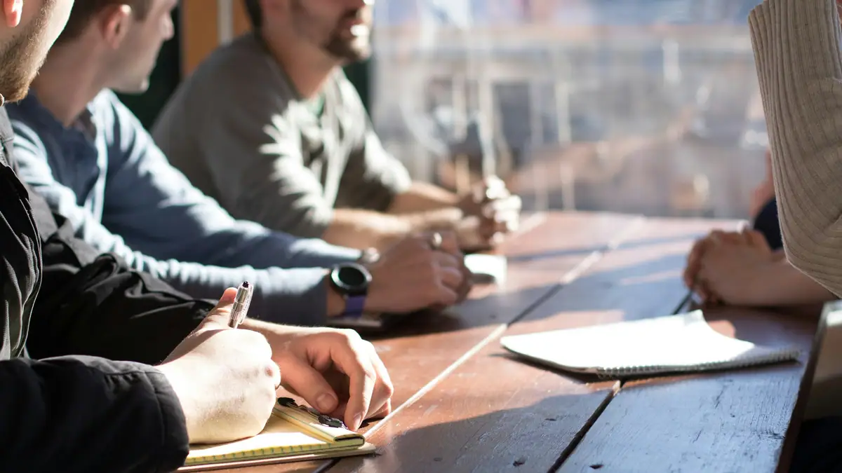 Loan officers reviewing applications around a conference table
