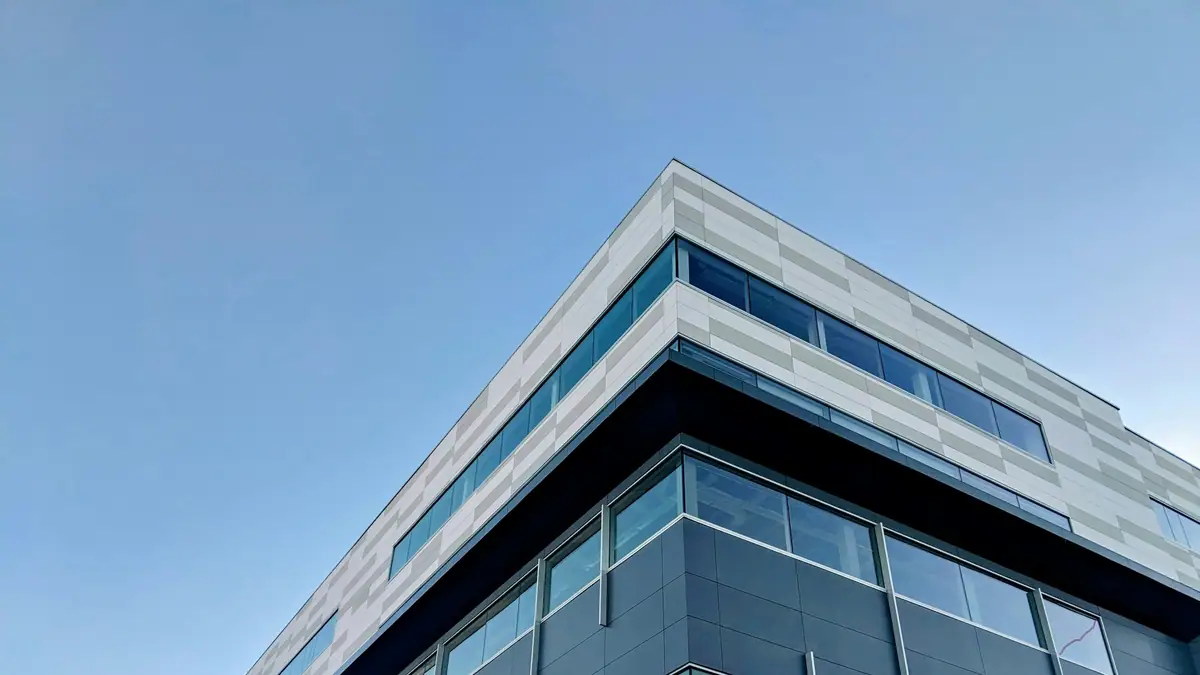 Modern commercial office building against a blue sky