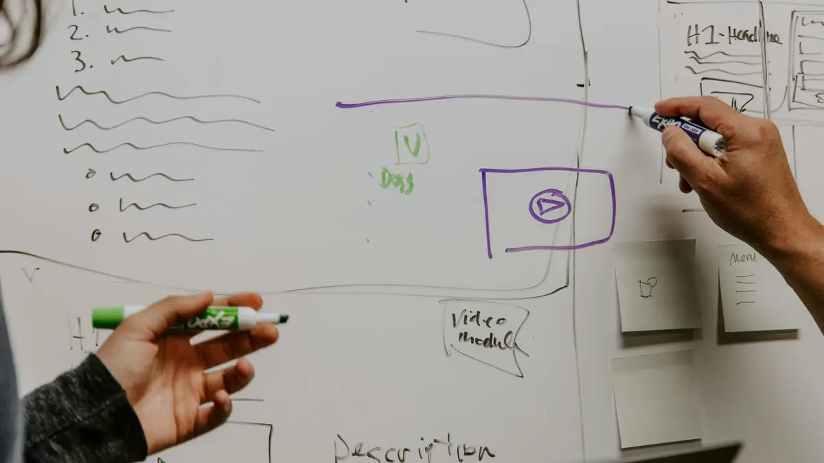 Marketers sketching a campaign plan on a whiteboard