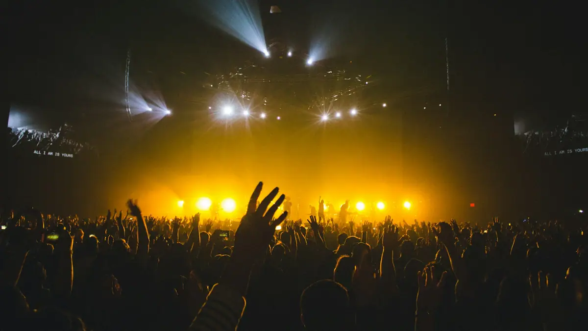 Concert stage lighting over a crowd