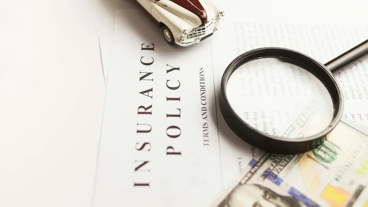 Insurance policy document under a magnifying glass