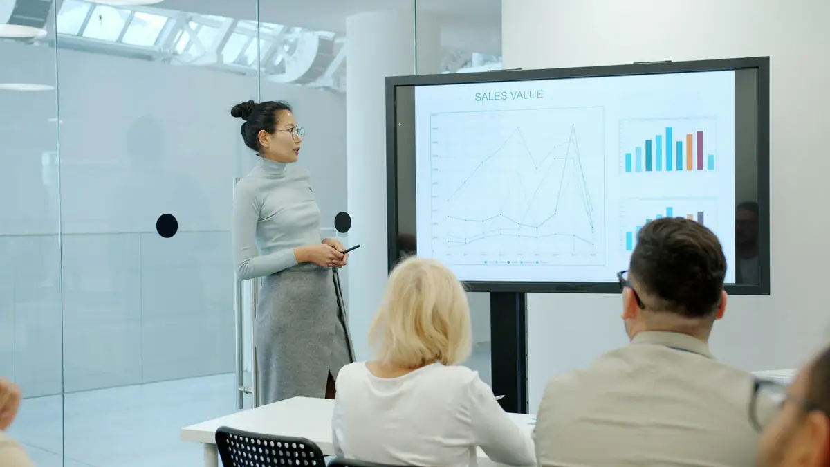 Consultant presenting a chart to a client team