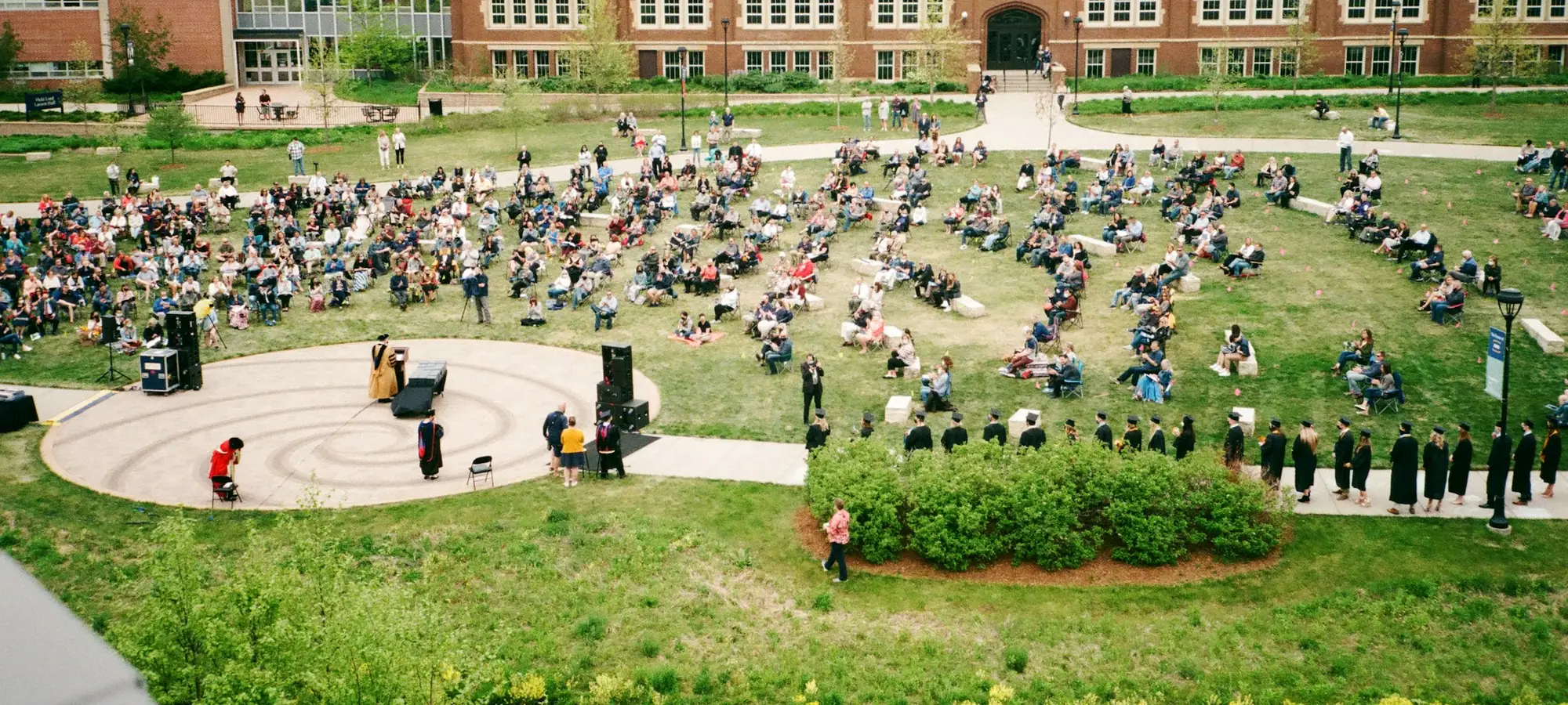 Students gathered on a university campus lawn