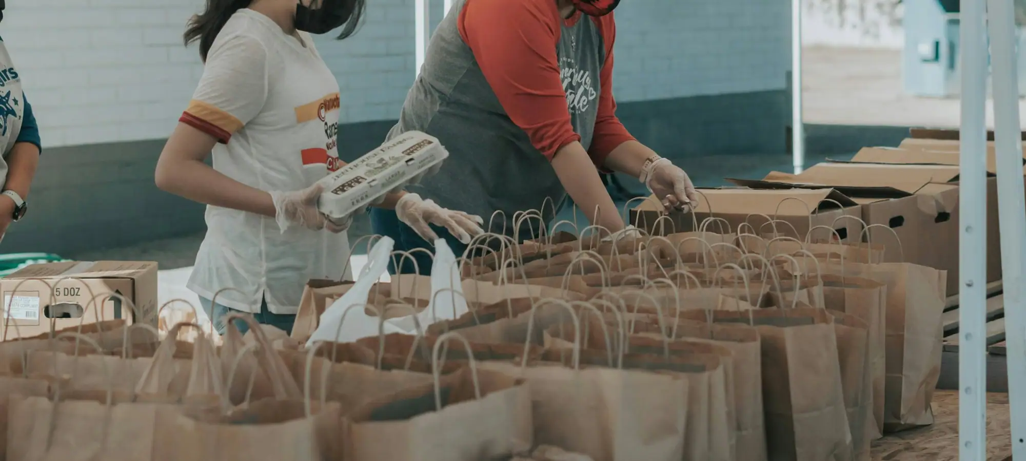 Food bank volunteers packing grocery bags