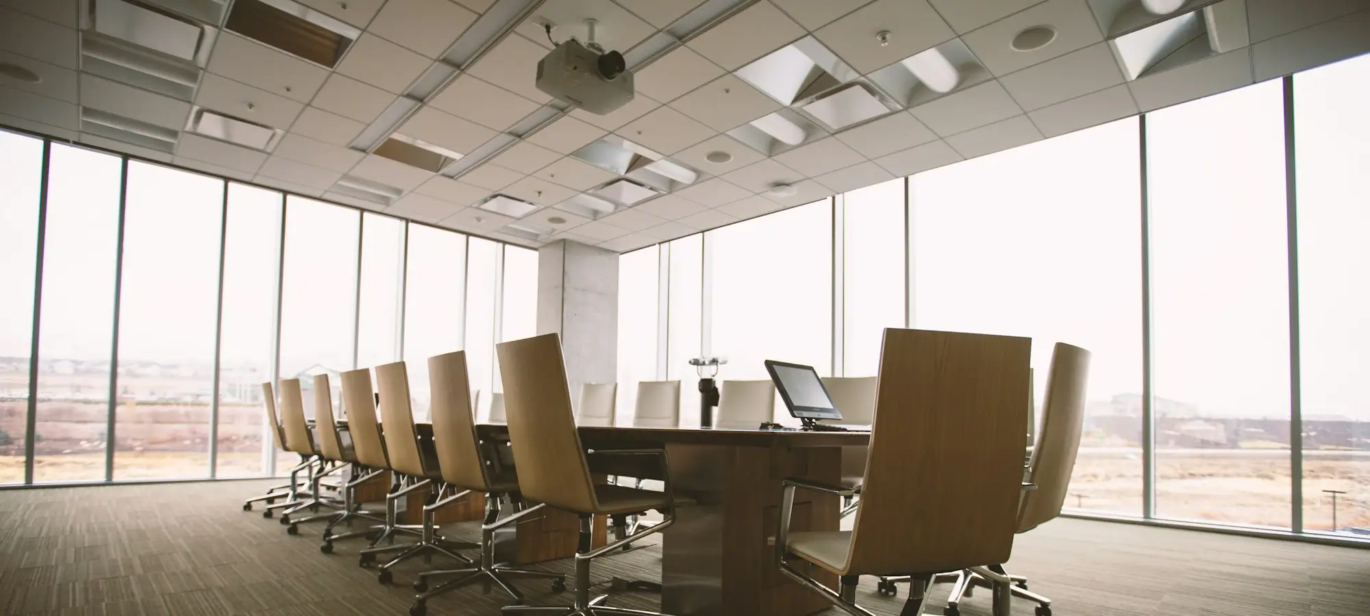 Empty boardroom with a long conference table