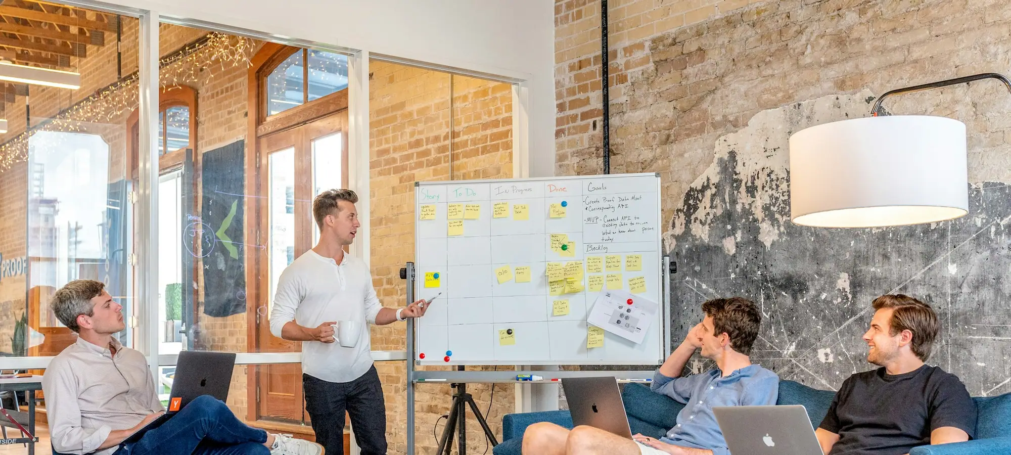 Consulting team working through a plan on a whiteboard
