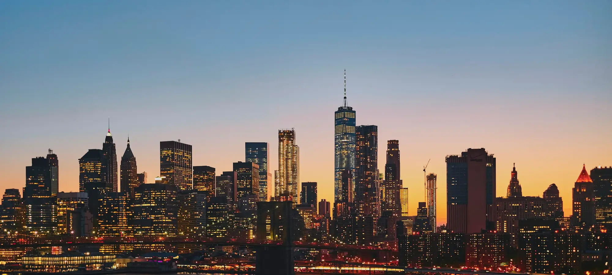 Lower Manhattan skyline and the East River at dusk