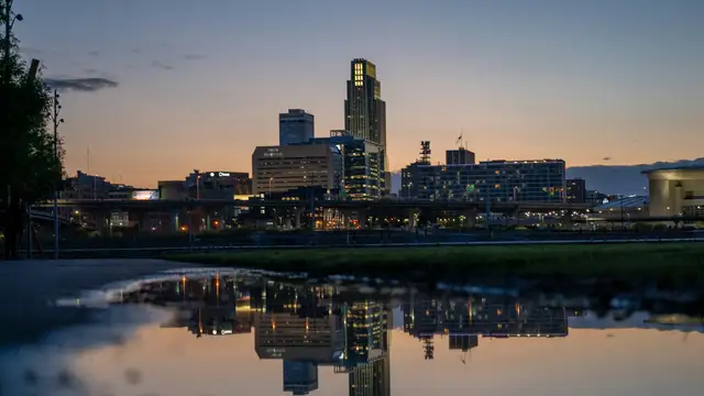 Downtown Omaha skyline reflected at dusk