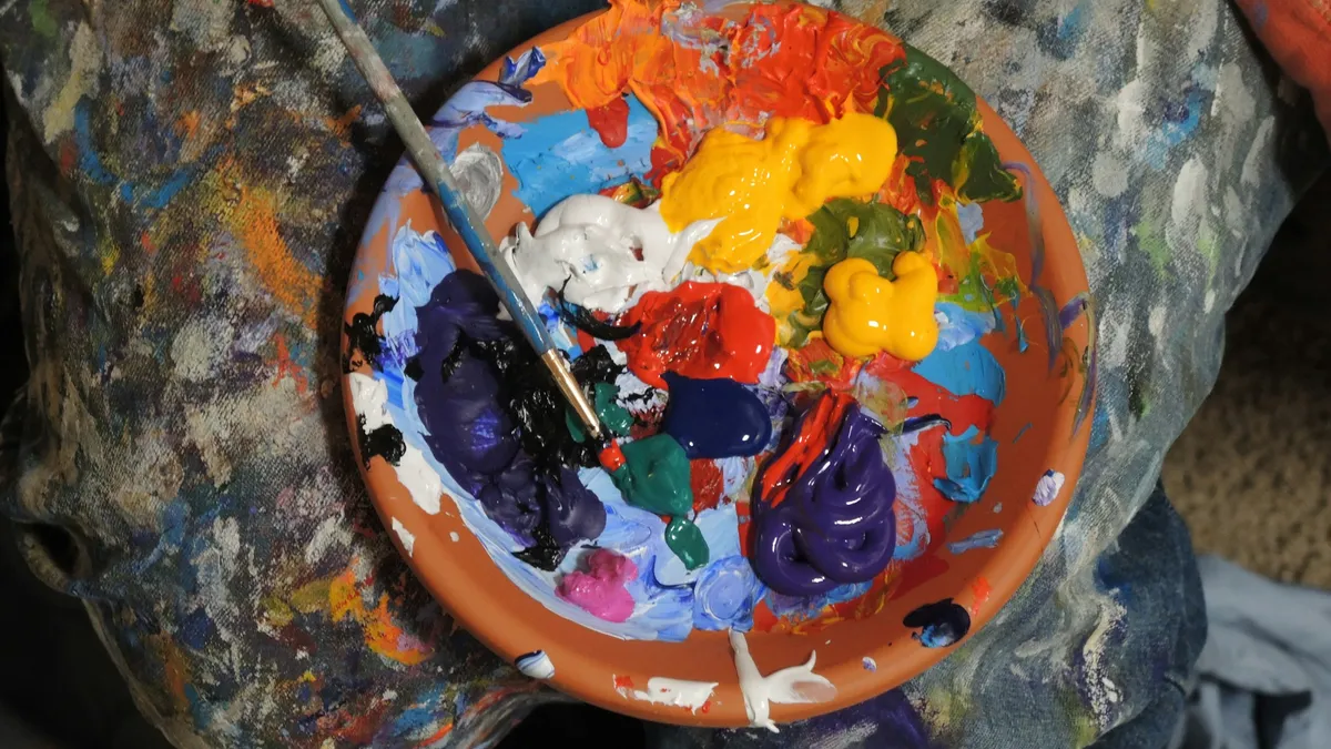 Bright paints mixed on a well-used palette