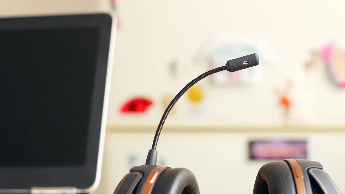 Headset resting in front of a laptop