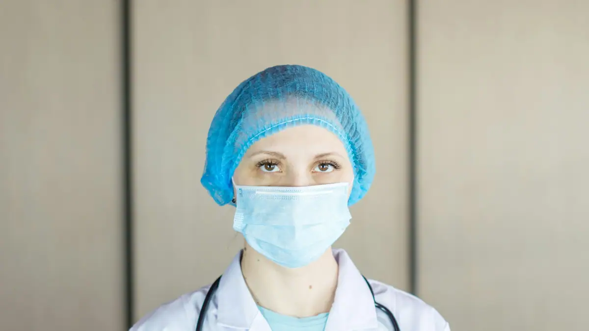 Clinician in a surgical cap and mask