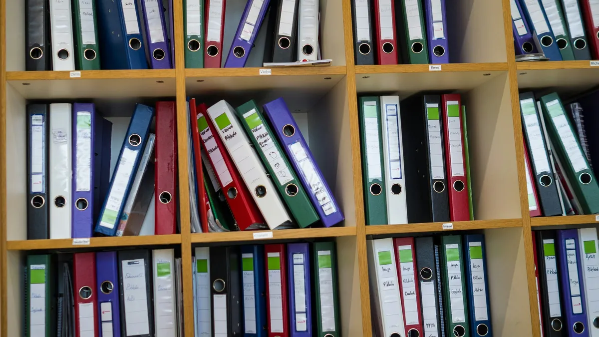 Shelves of labeled binders and folders