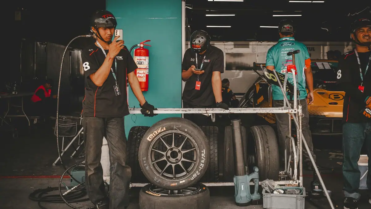 Race pit crew preparing tires in the garage