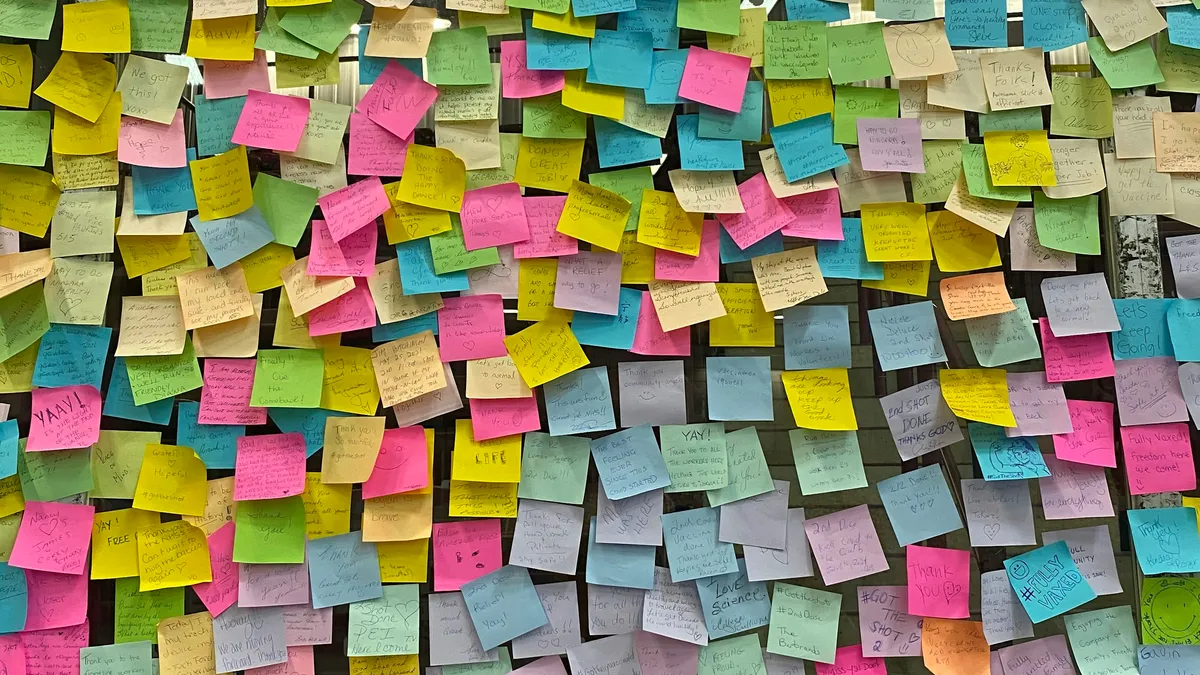 Wall covered with colorful sticky notes from a planning workshop