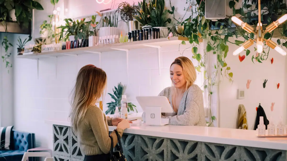 Shop owner serving a customer at the counter