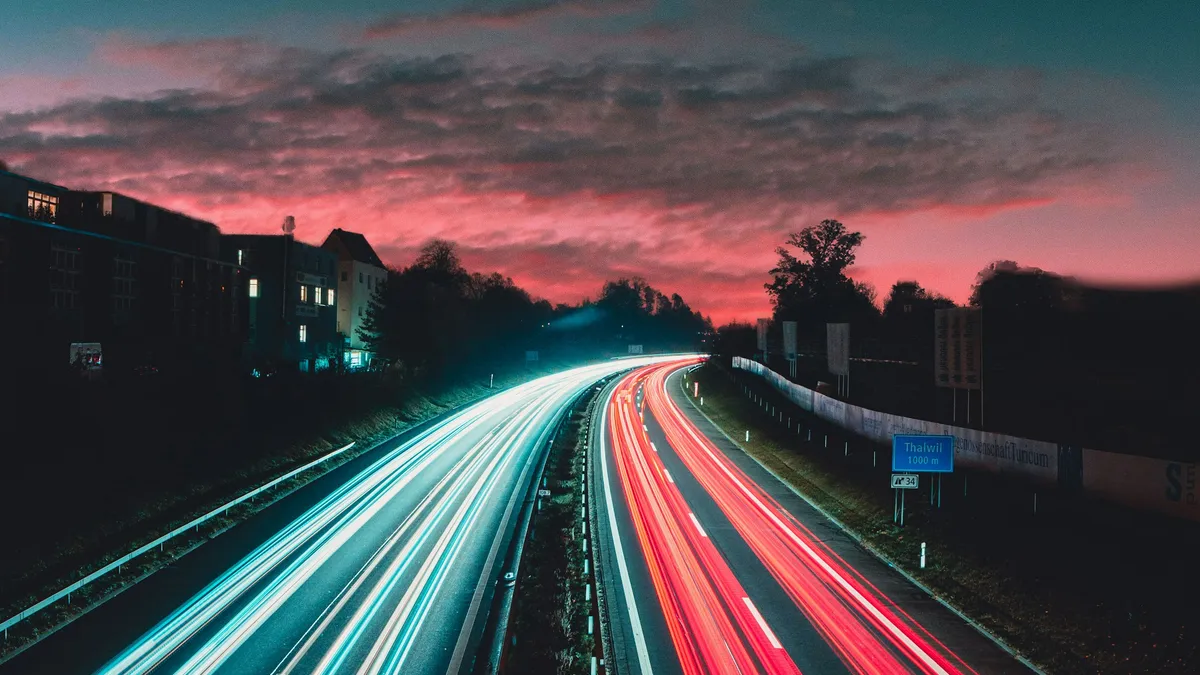 Long-exposure light trails of highway traffic at dusk