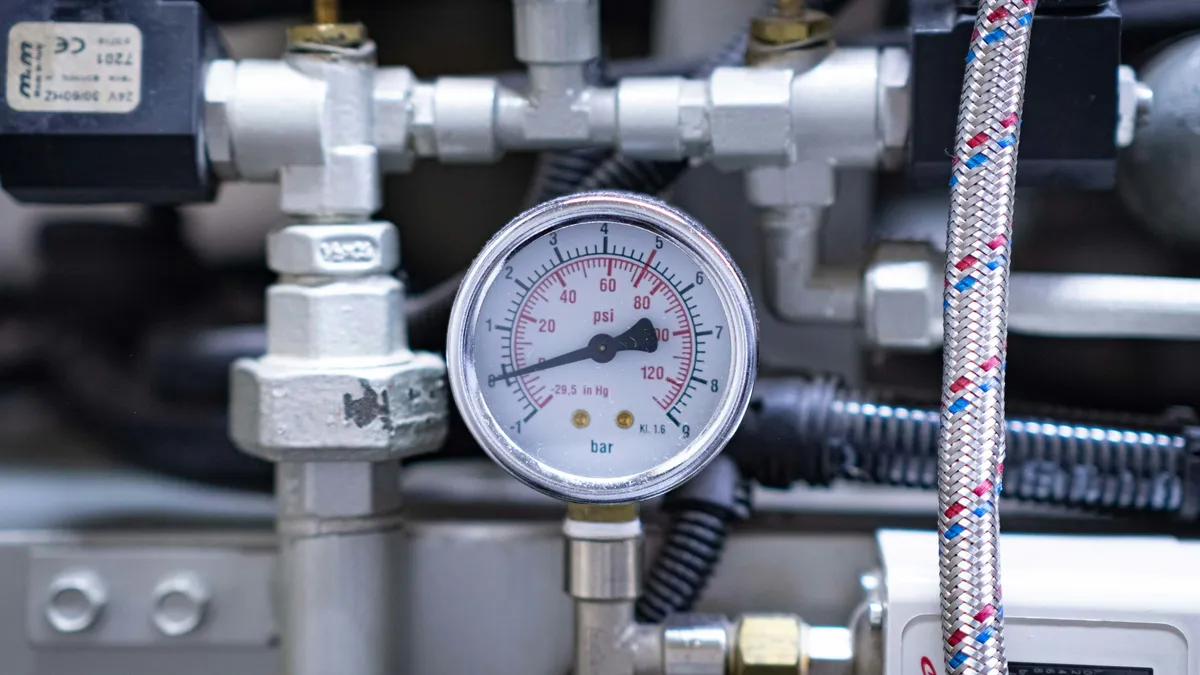 Pressure gauge on industrial equipment piping