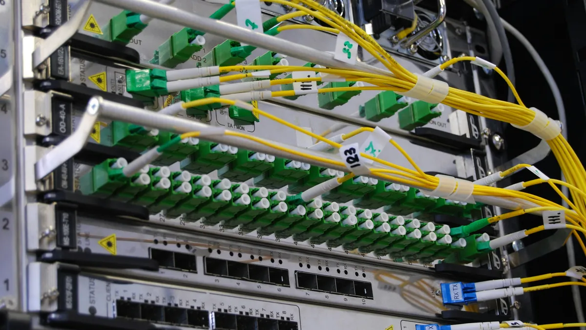 Fiber optic cables connected to a network switch in a server rack