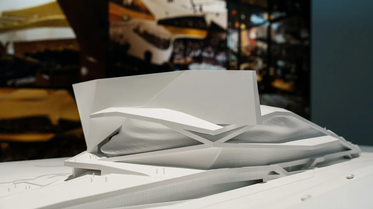 White architectural model of a building with flowing forms
