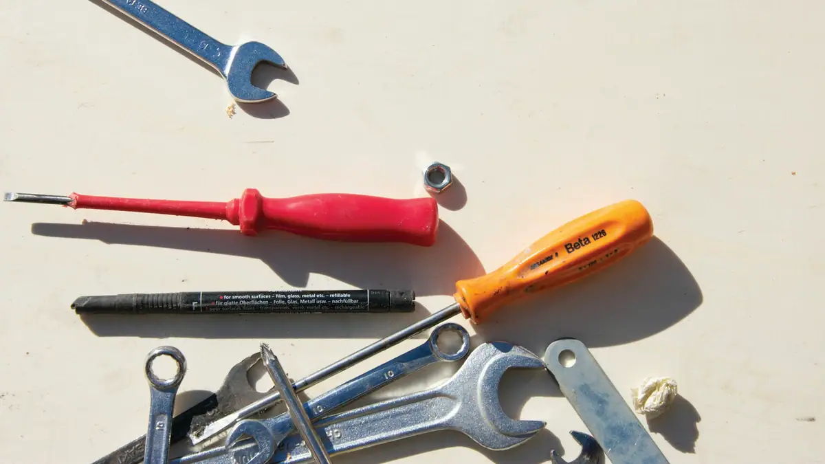 Wrenches and screwdrivers laid out on a surface