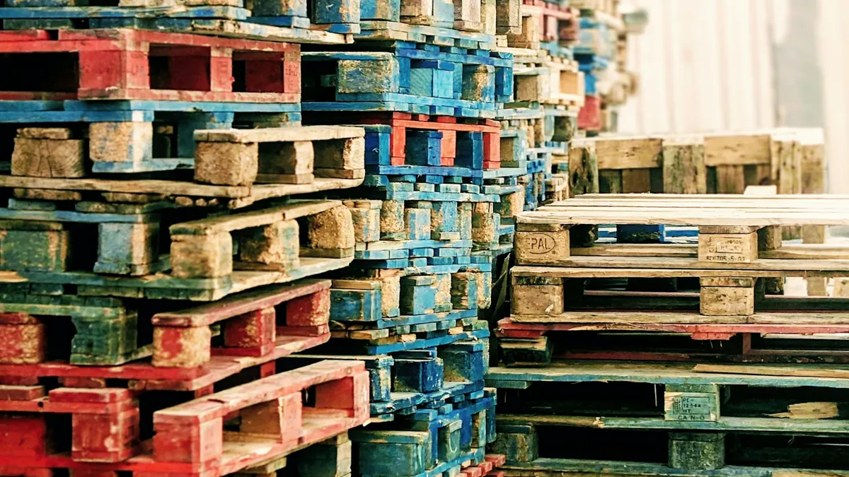 Large stack of colorful wooden pallets