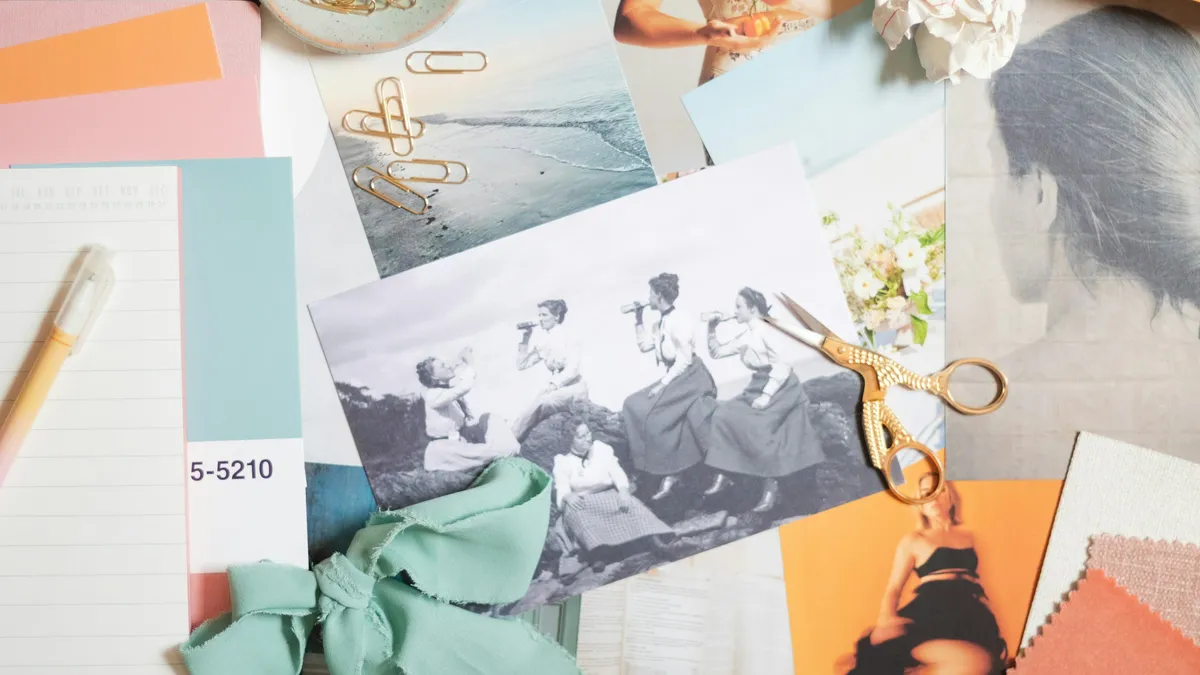 Mood board of photos, swatches and gold scissors on a desk