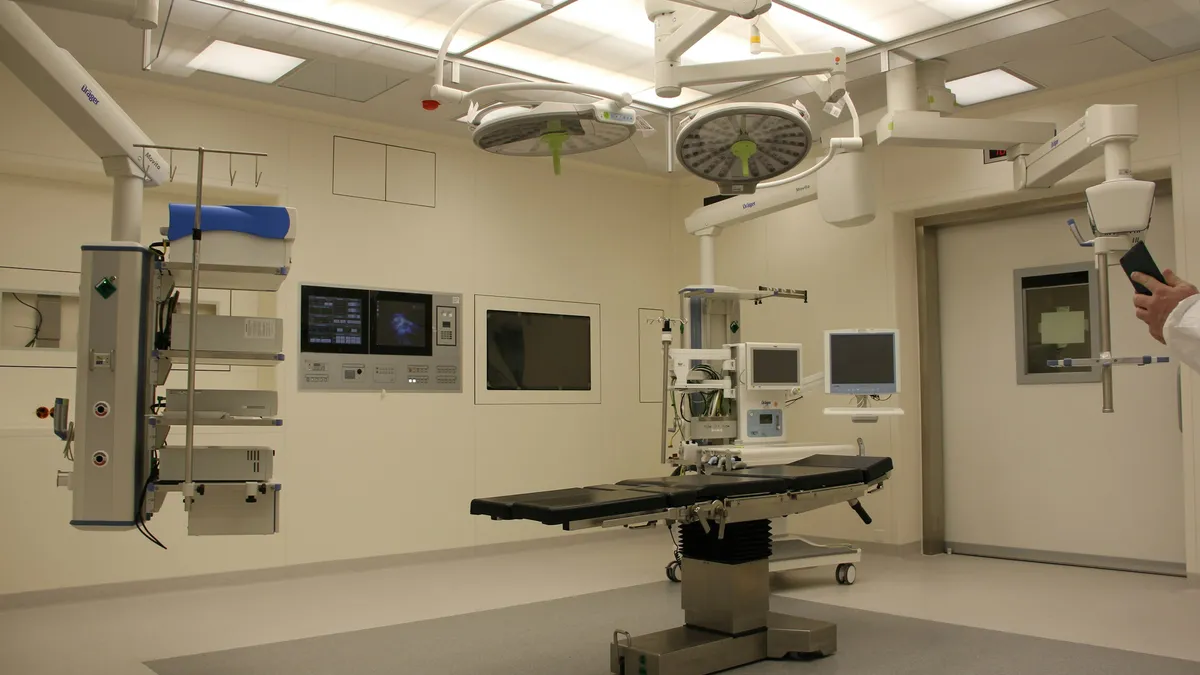 Operating room with surgical table and equipment booms