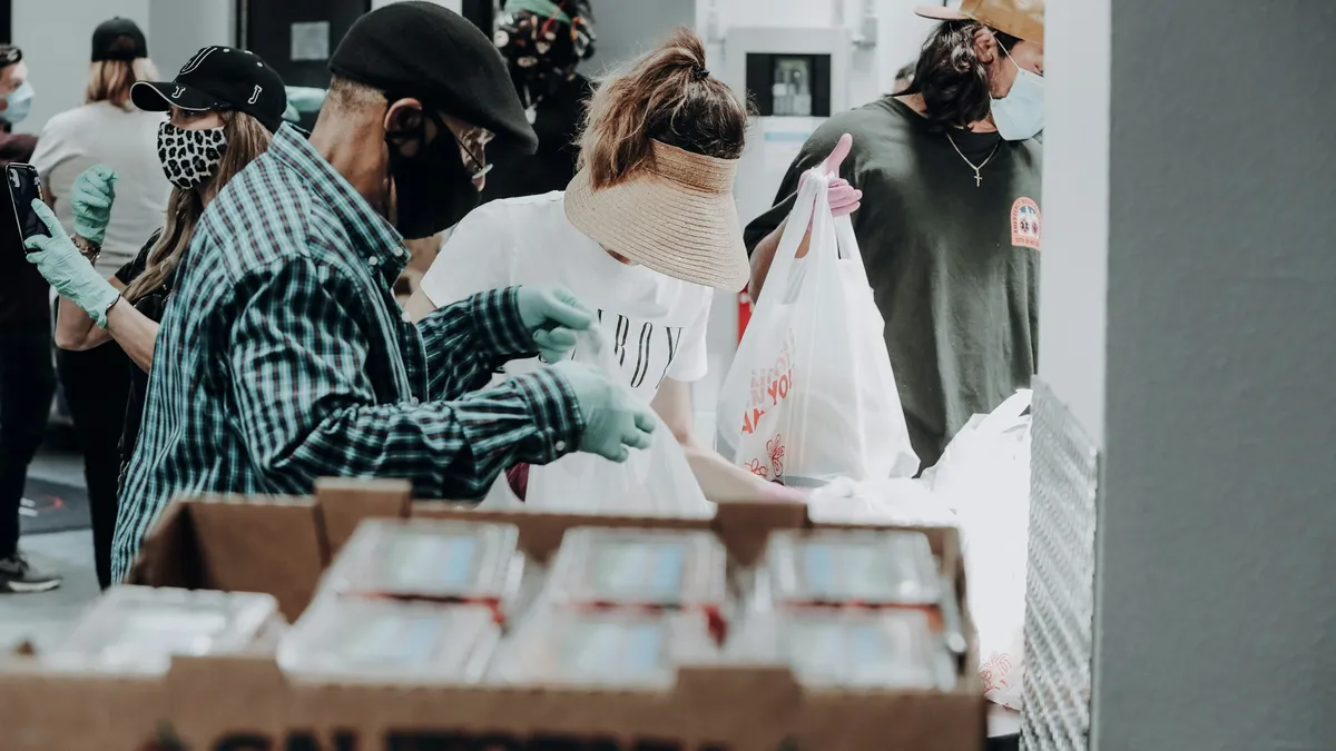 Volunteers packing donated food into bags
