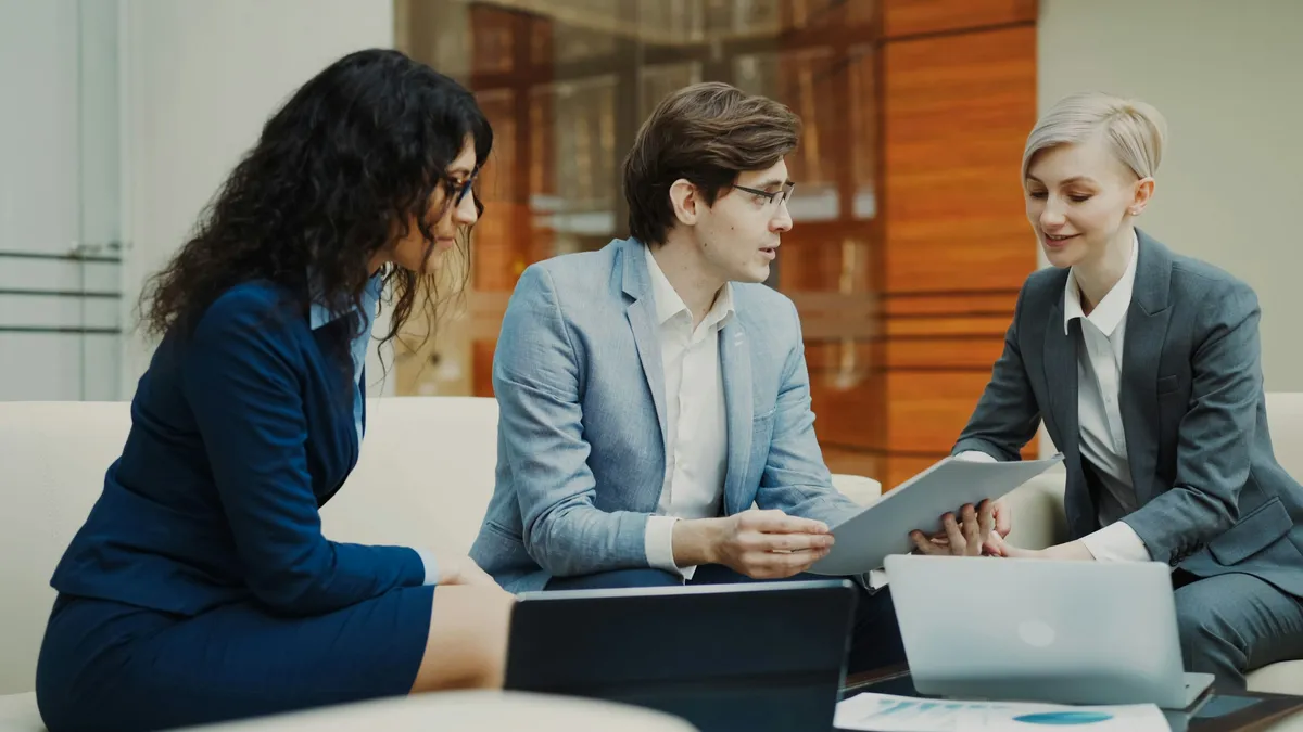 Advisors reviewing documents with a client at a table