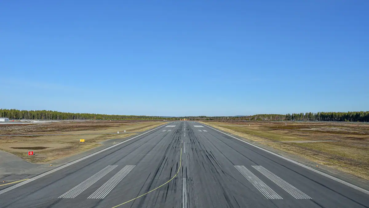 Airport runway under a clear blue sky