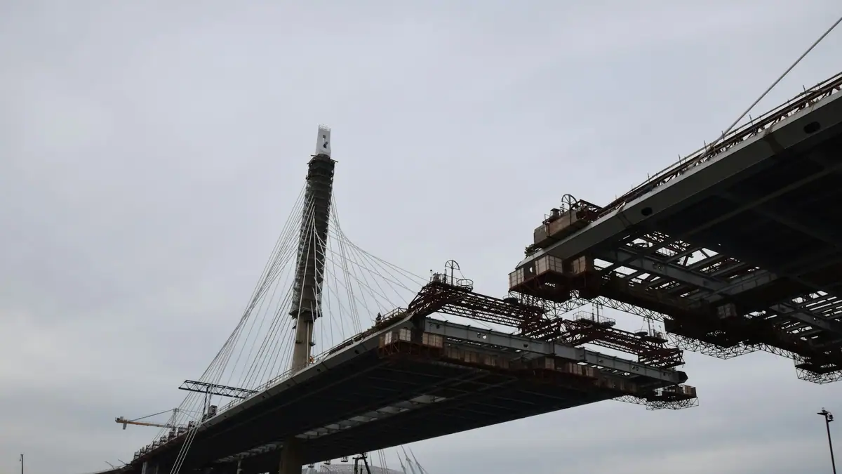 Two halves of a bridge being joined mid-span