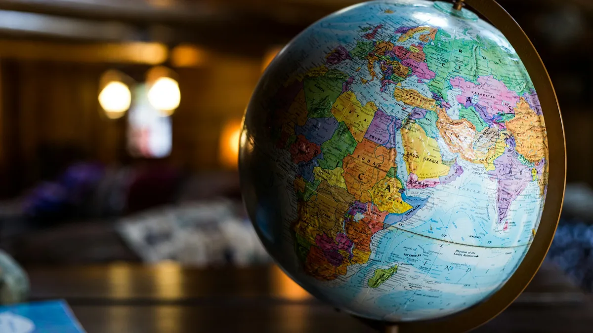 Colorful desk globe on a wooden table in warm light