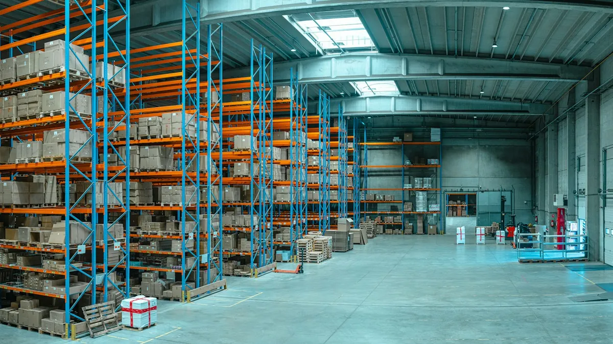 Tall shelving units stocked with boxes in a large warehouse