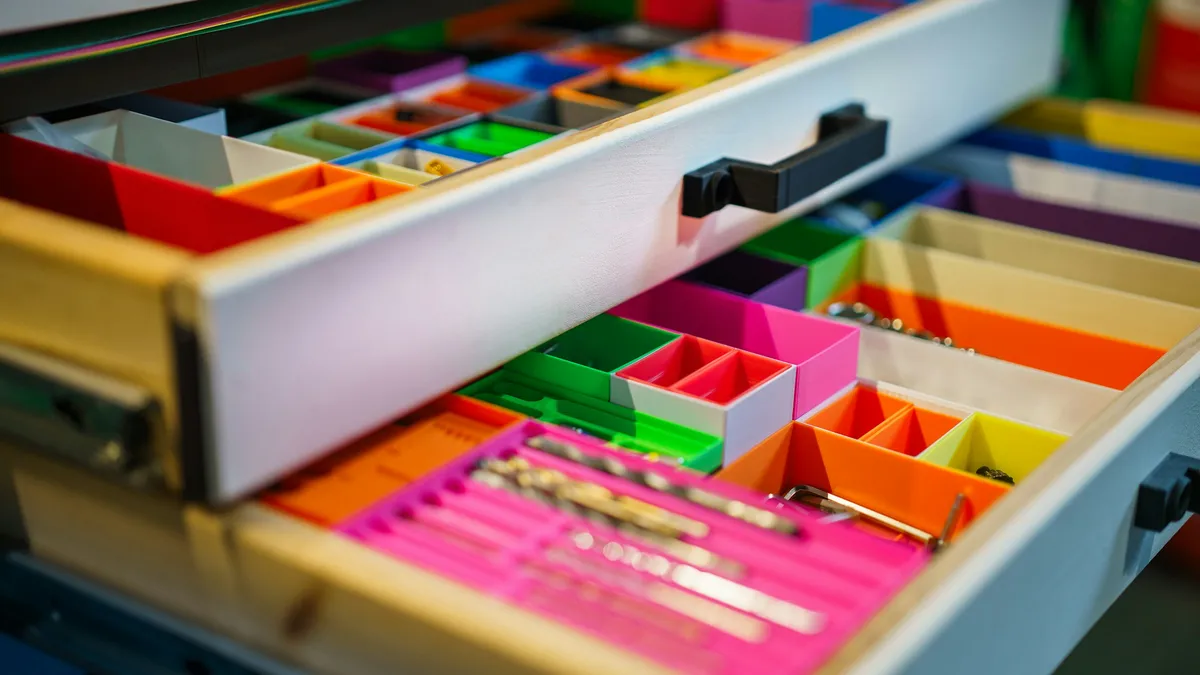 Open drawers with colorful sorting compartments