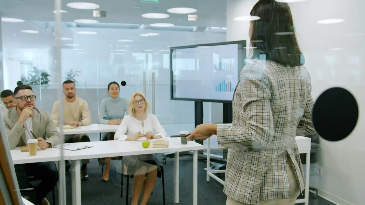 Presenter leading a training session in a modern office