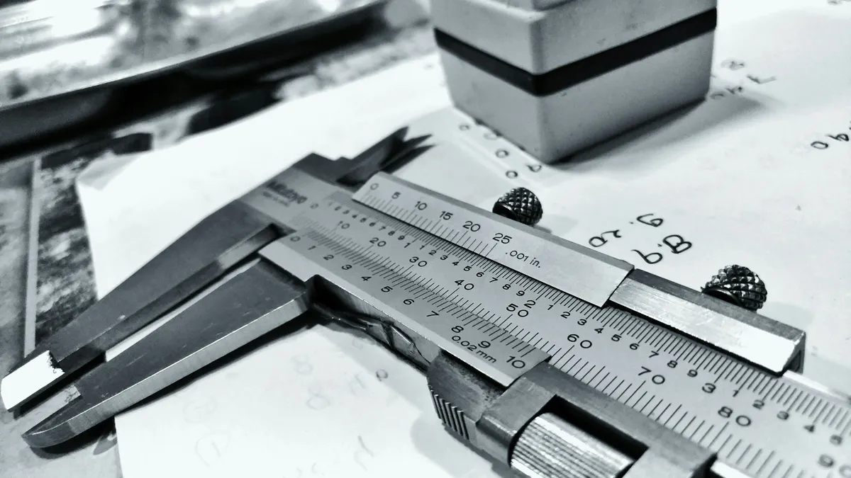 Steel vernier caliper resting on a workbench