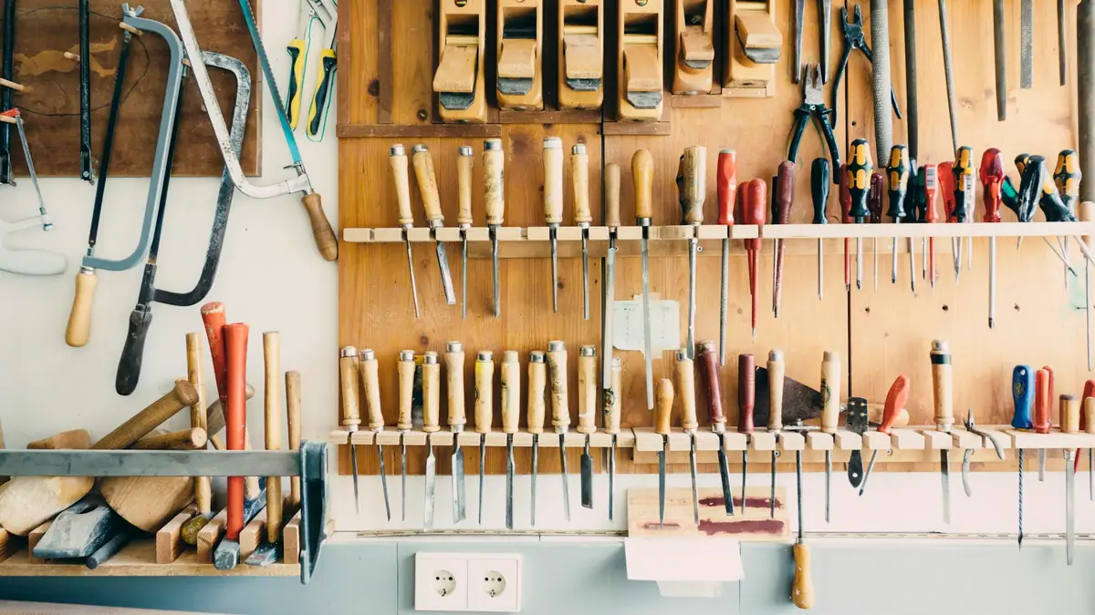 Wall of hand tools organized by type
