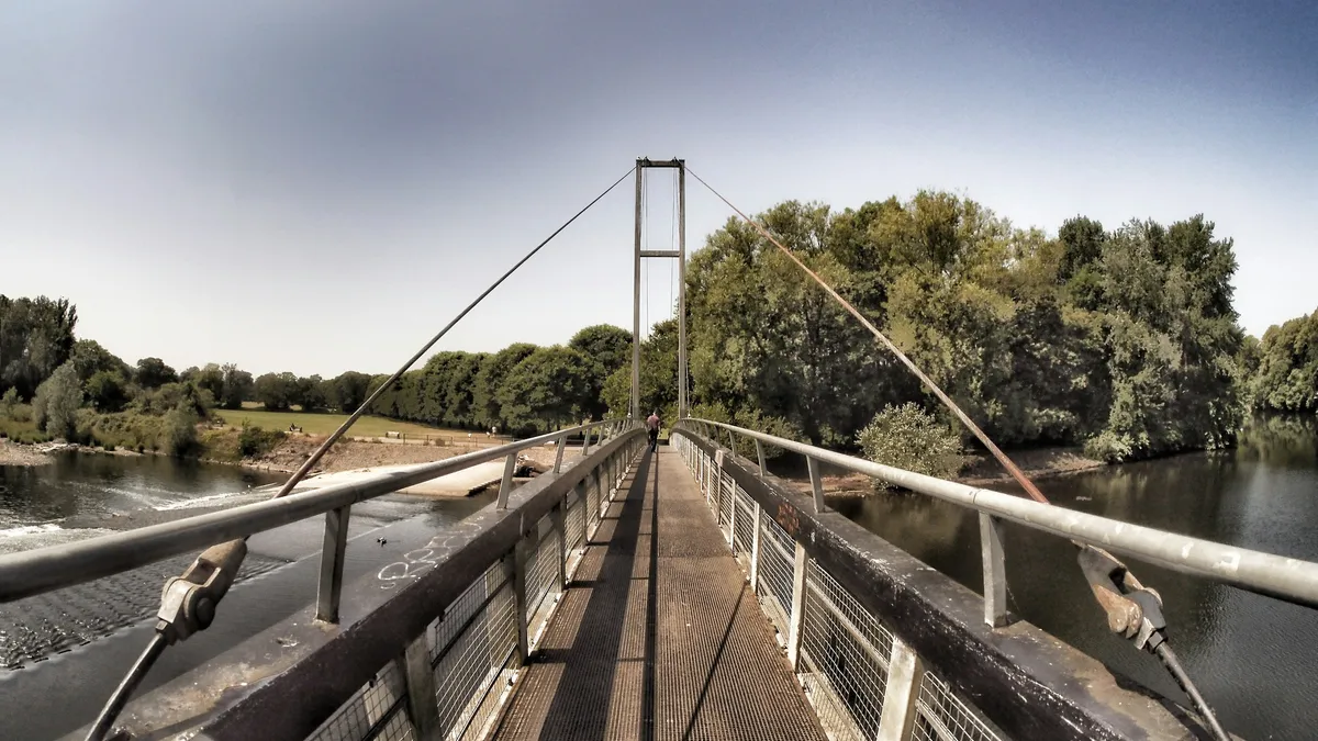 Suspension footbridge leading across a river